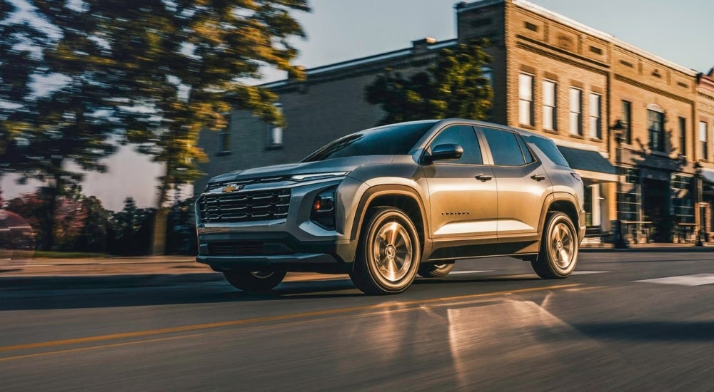 Silver 2026 Chevy Equinox for sale near Pelham driving on a city street