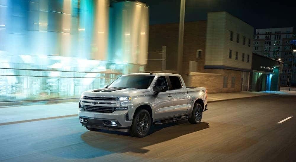 A silver 2020 Chevy Silverado 1500 Rally is shown from the front at an angle after leaving a dealer that has a used Chevy Silverado 1500 for sale.