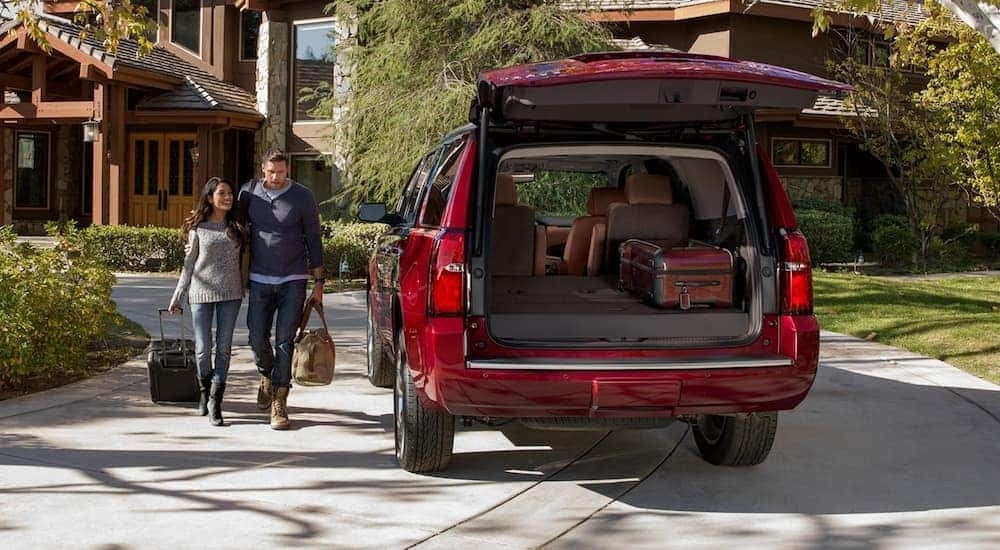 A red 2020 Chevy Tahoe is shown from the rear while the liftgate is open.