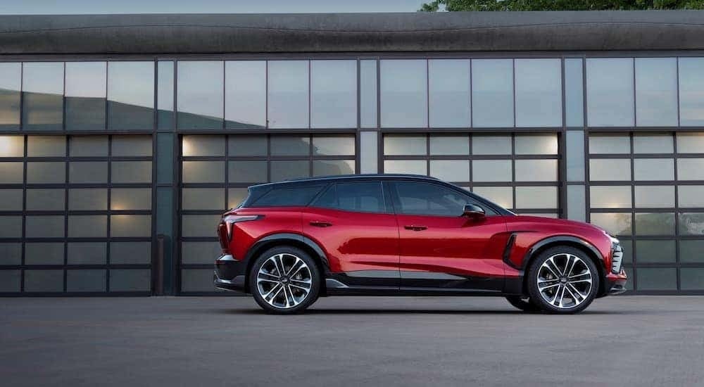 A red 2024 Chevy Blazer EV SS is shown at a side angle while parked outside a building.