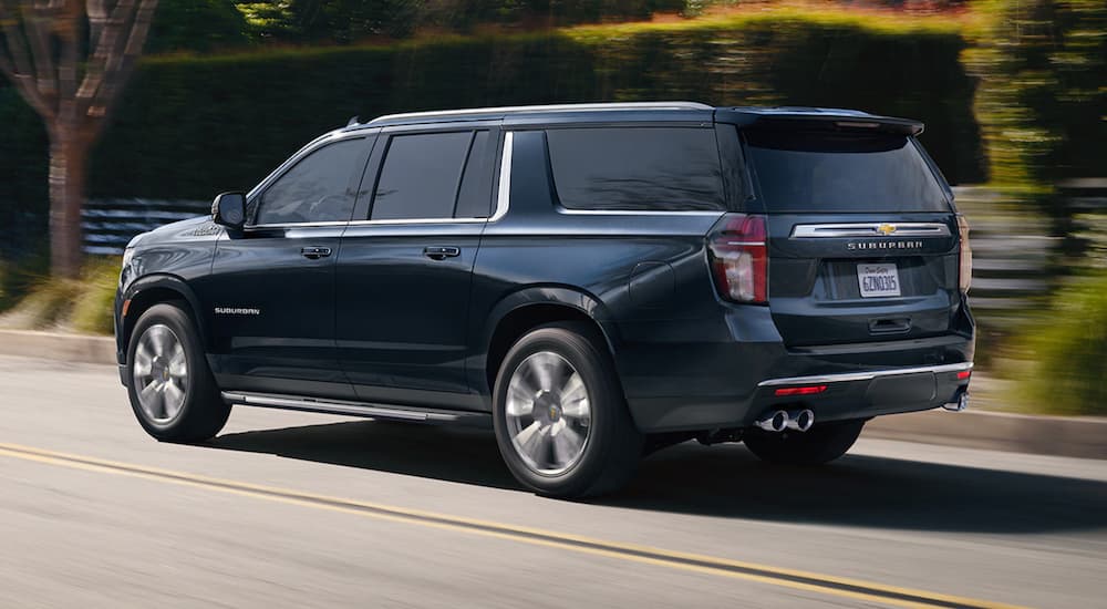 Blue 2023 Chevy Suburban High Country driving on a street