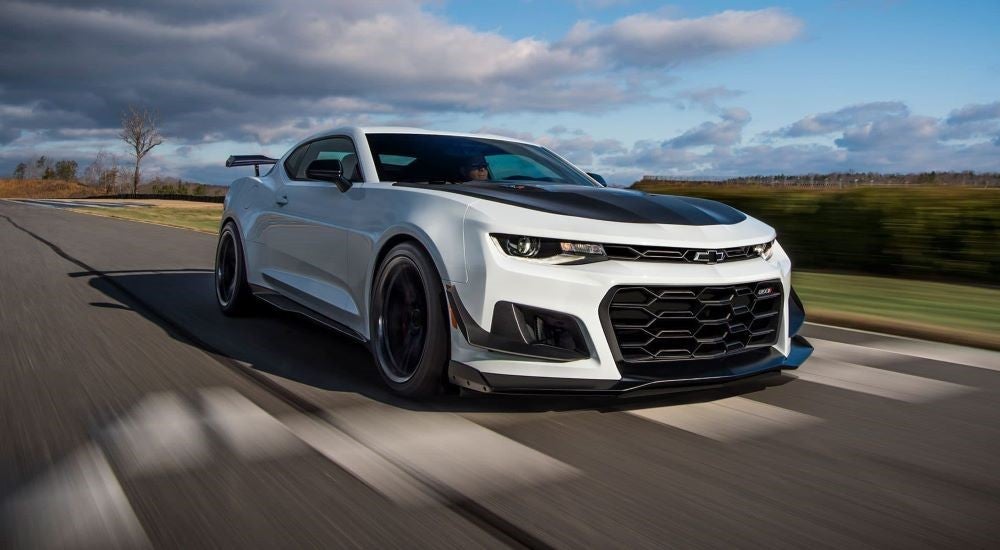 White 2023 Chevy Camaro SS 1LE driving to a Pelham Chevy dealer
