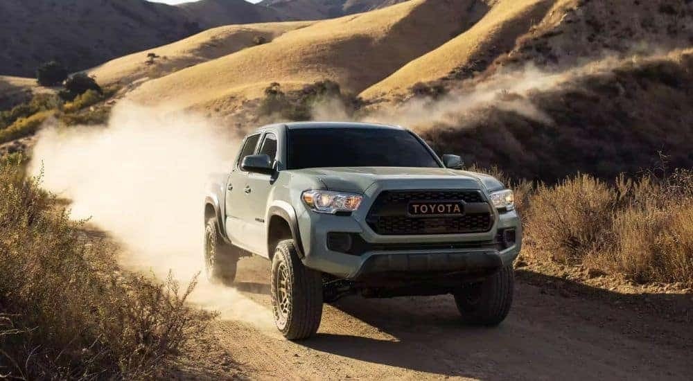 A light blue 2023 Toyota Tacoma SR5 Trail Edition is shown off-roading.