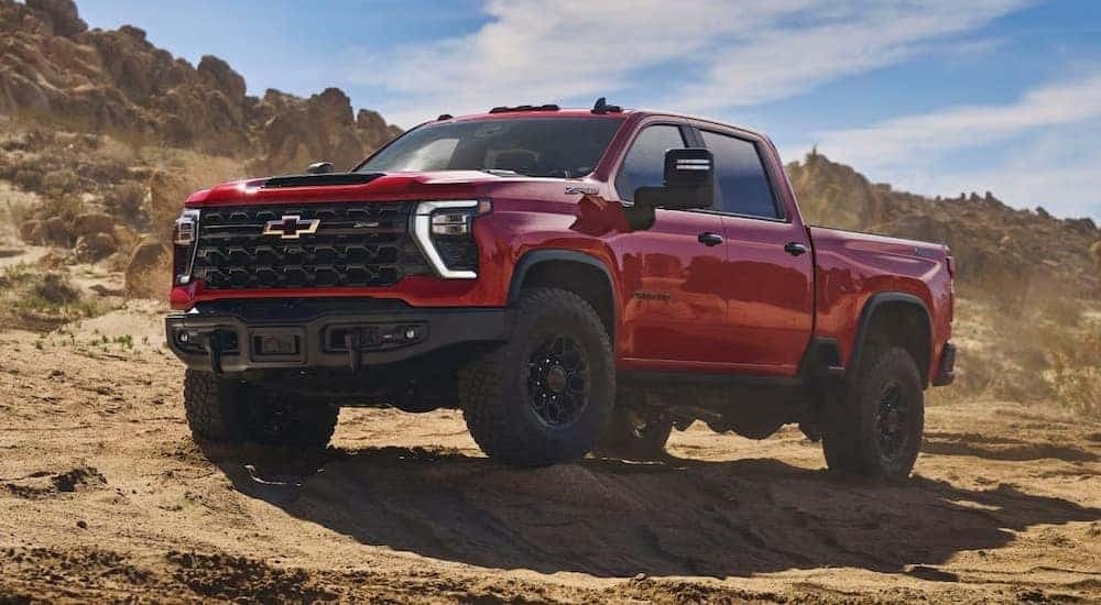 A red 2026 Chevy Silverado 2500 HD ZR2 parked off-road.