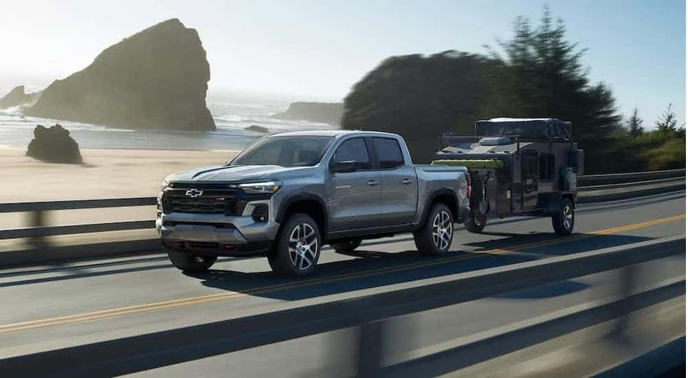 A silver 2024 Chevy Colorado Z71 is shown driving to view a Chevy Colorado for sale