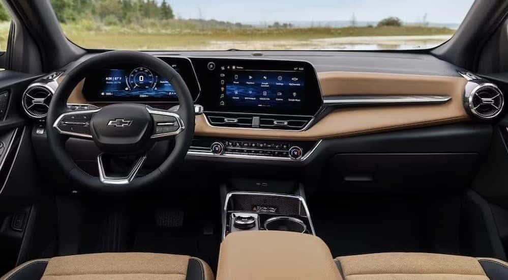 The black and tan interior and dash in a 2025 Chevy Equinox is shown.