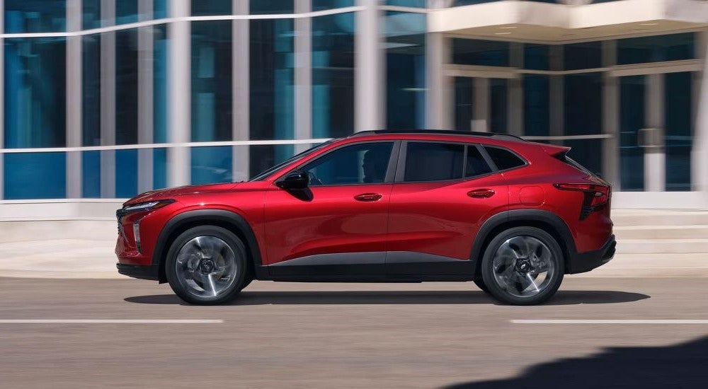 Red 2025 Chevy Trax RS driving on a city street