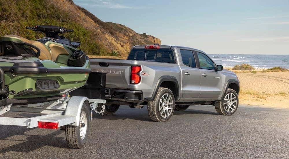 Rear view of a silver 2024 Chevy Colorado Z71 towing a jet ski.