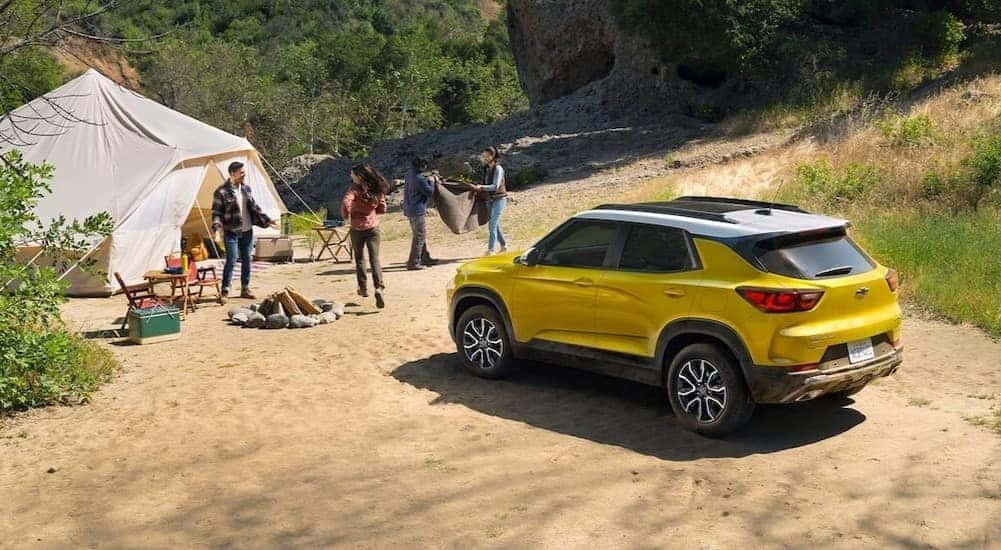 A yellow 2025 Chevy Trailblazer ACTIV is shown parked near a tent.