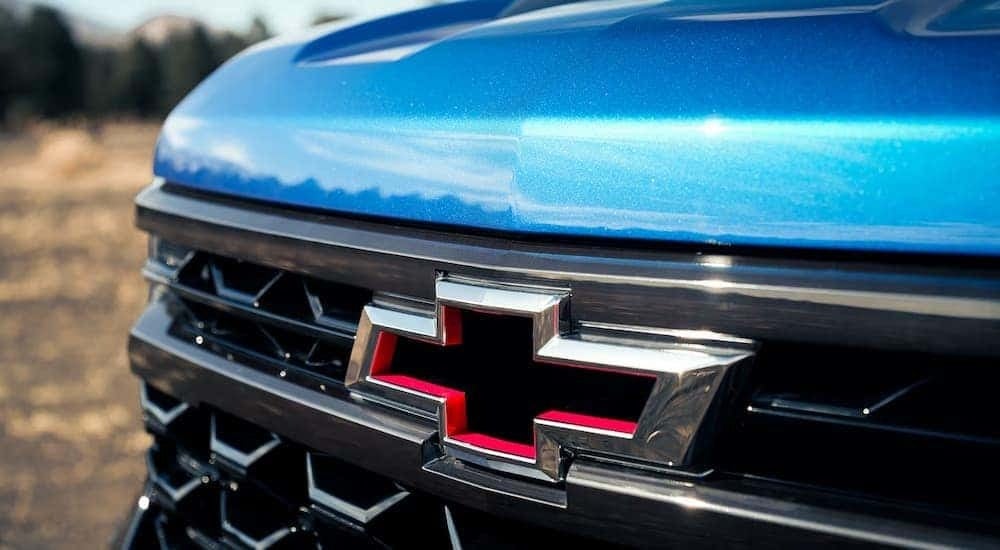 A close up of the Chevy badge of a blue 2024 Chevy Silverado 1500 ZR2.