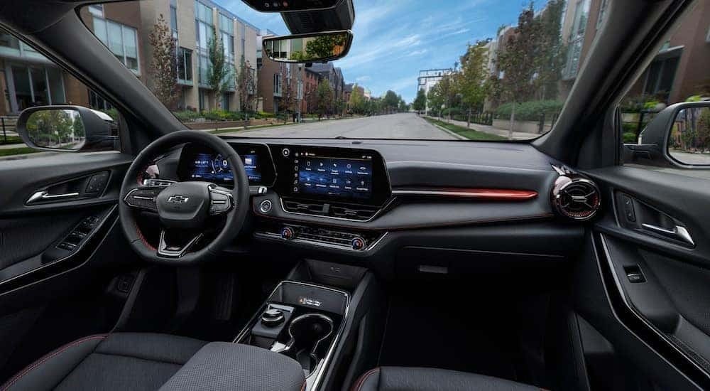 The black interior of a 2025 Chevy Equinox RS is shown from the passenger side.