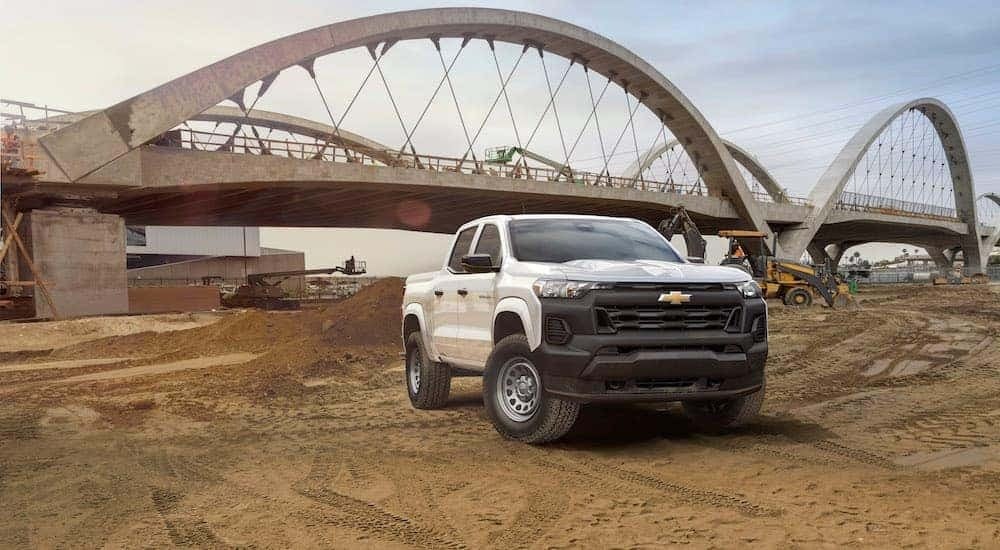 A white 2023 Chevy Colorado WT is shown from the front at an angle.