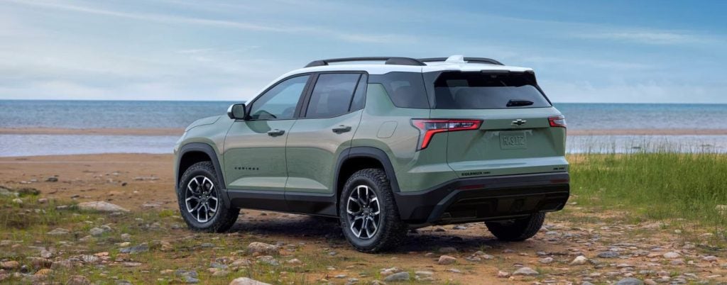 Green 2026 Chevy Equinox ACTIV parked near a lake