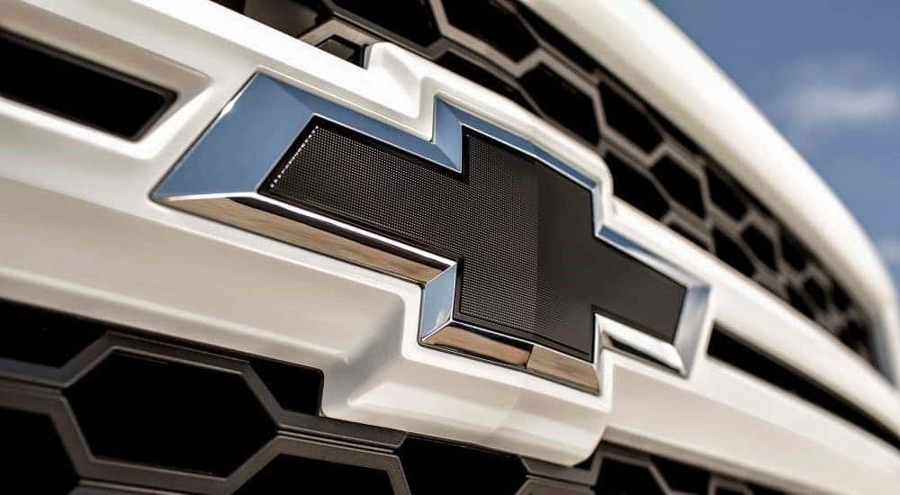 A close up shows the Chevy badge on a white 2015 Chevy Silverado1500 Rally Edition