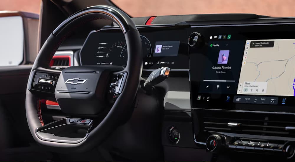 Close-up on the steering wheel in the interior of a 2027 Chevy Silverado 1500