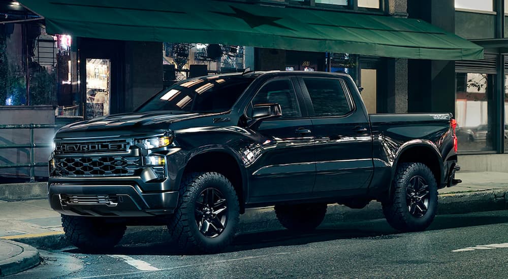 Black 2025 Chevy Silverado 1500 Trail Boss parked on a city street