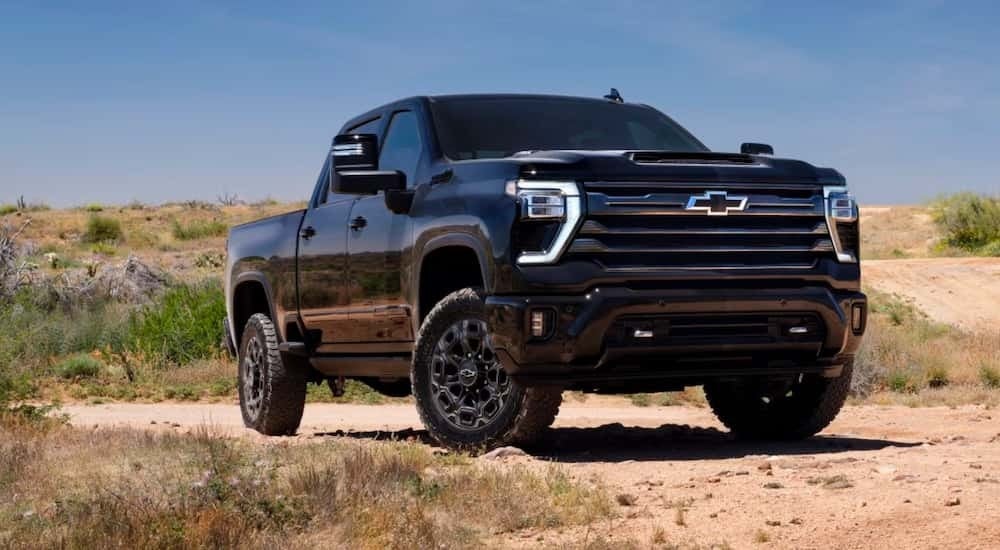 Black Chevy Silverado 2500 HD parked at an angle on dirt
