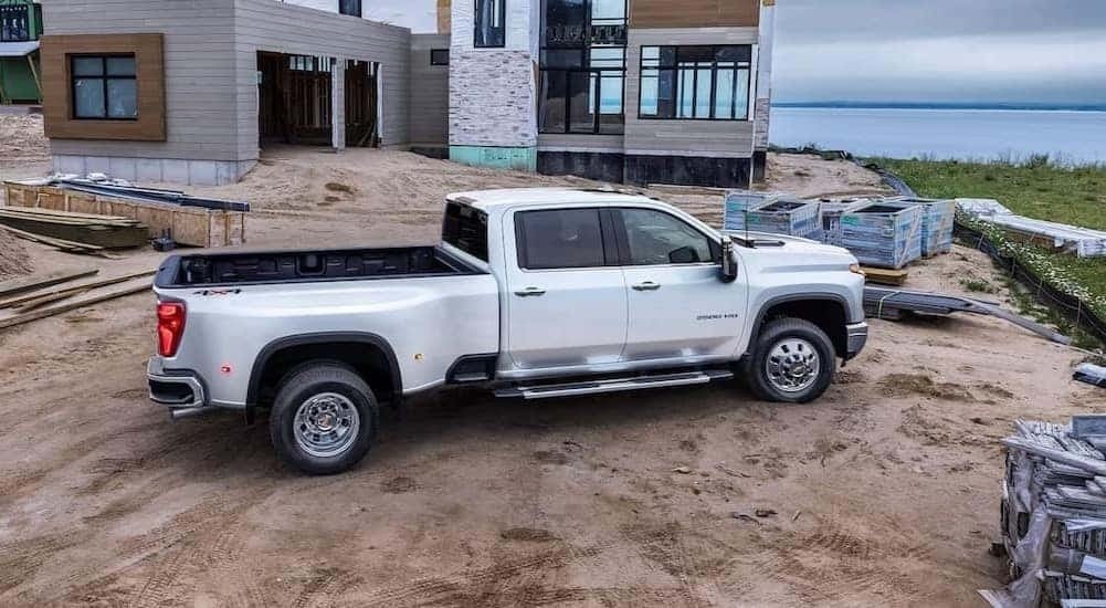 A white 2024 Chevy Silverado 3500 HD LTZ is shown parked on a construction site