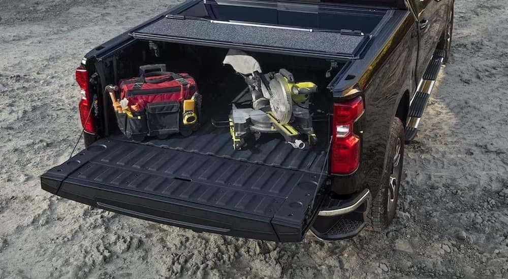 The black bed of a 2024 Chevy Silverado 1500 full of tools.