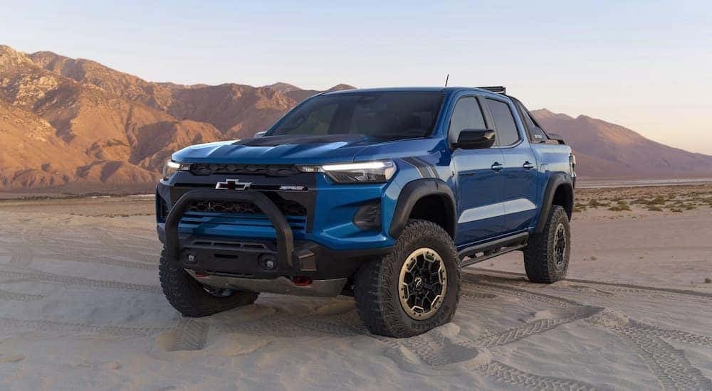 A blue 2024 Chevy Colorado ZR2 is shown from the front at an angle after leaving a dealer that has trucks for sale