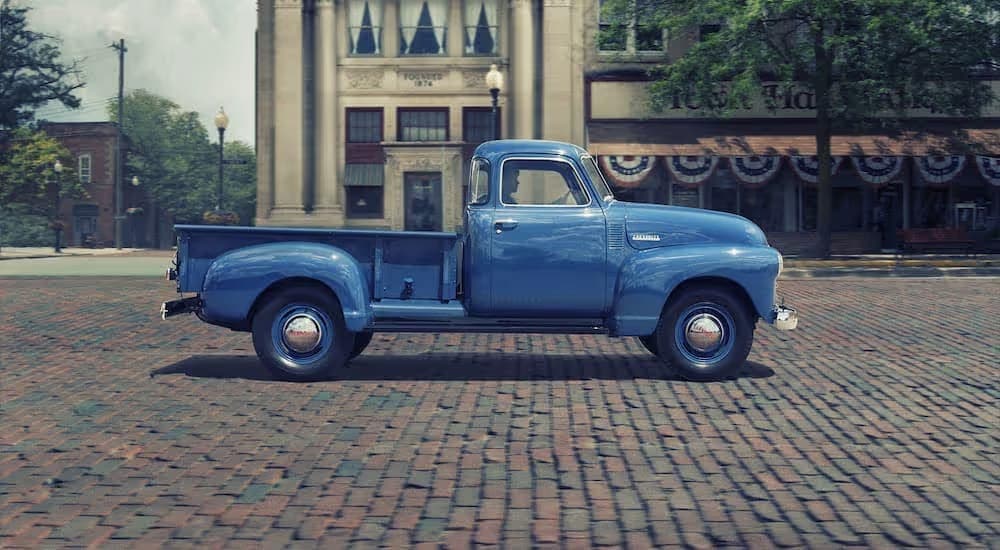 A blue 1955 Chevy 3100 is shown from the side.