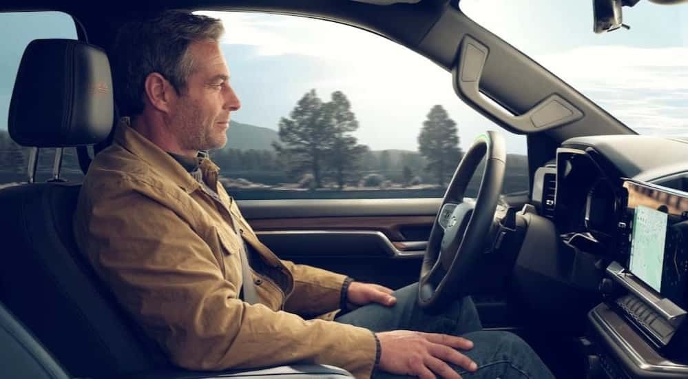 A person driving in a 2025 Chevy Silverado 1500 for sale near Mountain Brook