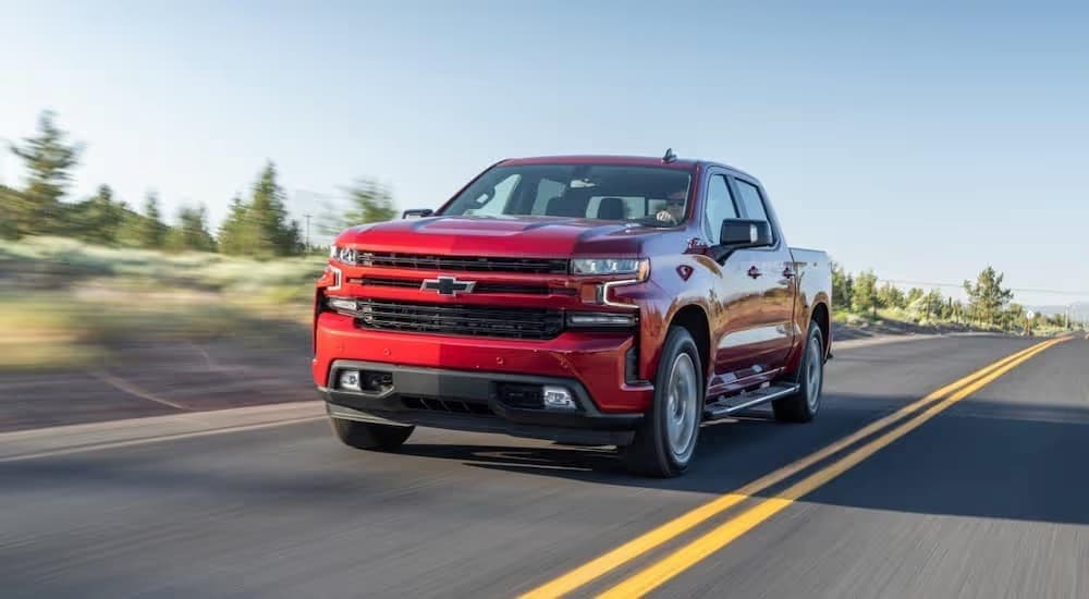 A red 2020 Chevy Silverado 1500 LTZ is shown driving on an open road.