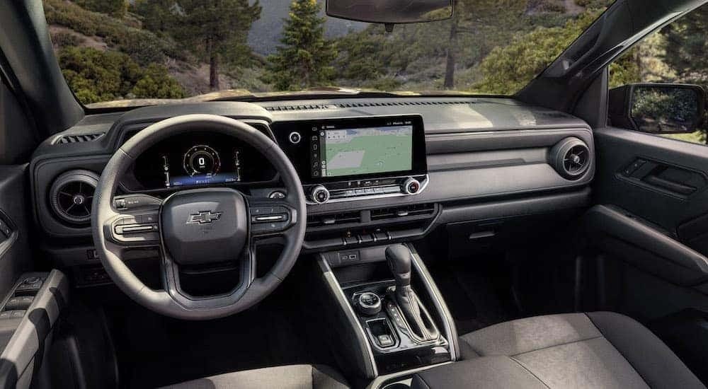 The black interior of a 2024 Chevy Colorado Trail Boss is shown from the driver's seat