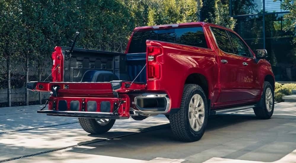 A red 2025 Chevy Silverado 1500 for sale near Mountain Brook parked near a building