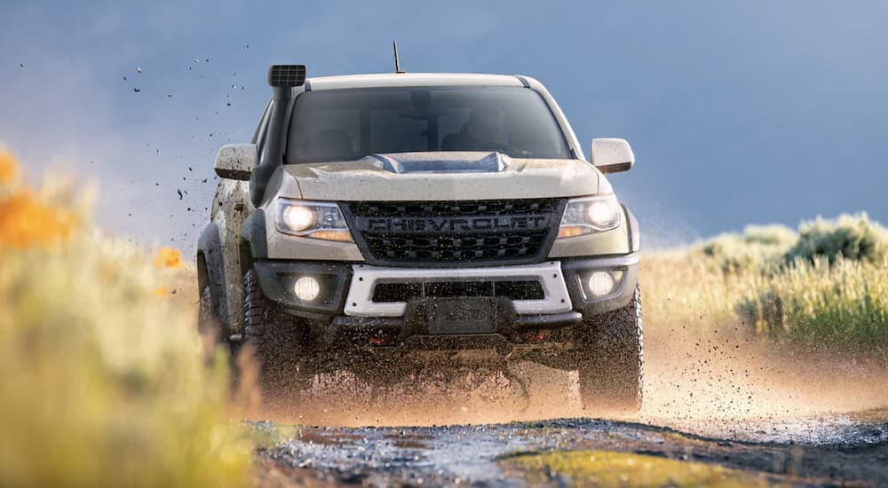 Tan 2022 Chevy Colorado ZR2 driving to a Chevrolet dealer