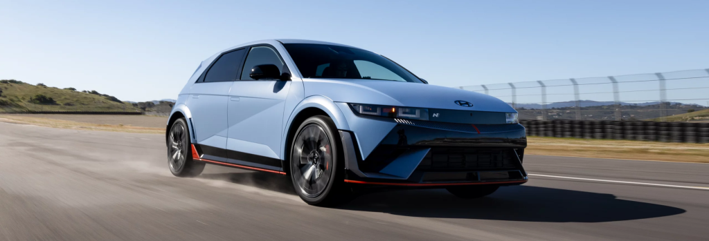 The 2026 Hyundai IONIQ 5 in motion on a road, highlighting its futuristic look and eco-friendly design.