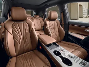 Interior of a Genesis luxury car showcasing brown leather seating and modern design features.