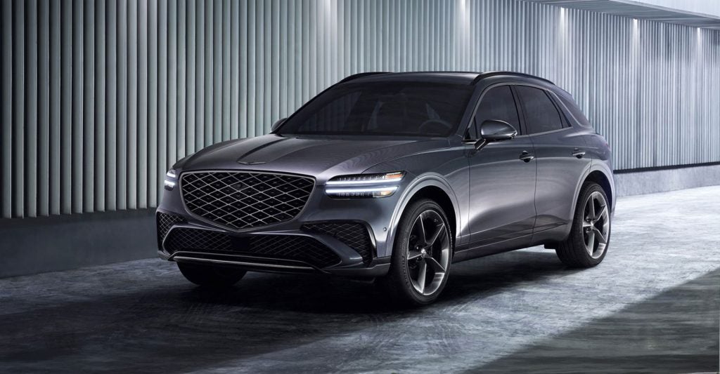 Gray Genesis luxury SUV parked in a modern, illuminated architectural setting.