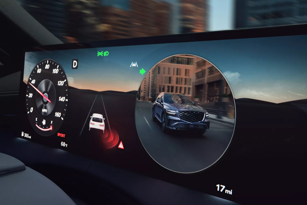 A digital dashboard display showing a Genesis car's speedometer, navigation, and a graphic of a vehicle on a road at dusk.