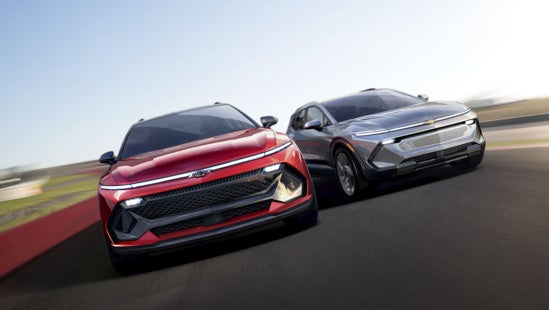 two Chevy Equinox EVs driving side by side on a racetrack