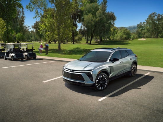 Chevy EV parked adjacent to a golf course