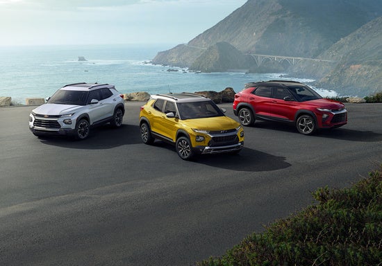 collection of Chevy vehicles parked on an oceanside cliff 