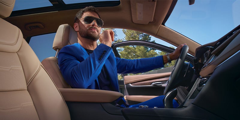 man driving Cadillac
