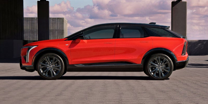 Side view of a 2025 red Cadillac OPTIQ