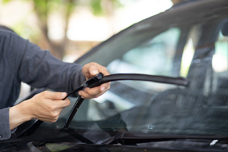mechanic putting on windshield wiper