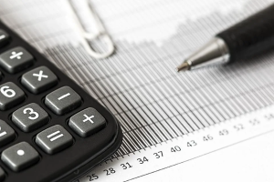 calculator, paperwork, and a pen