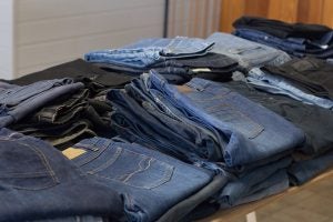 jeans at a thrift shop folded on a table