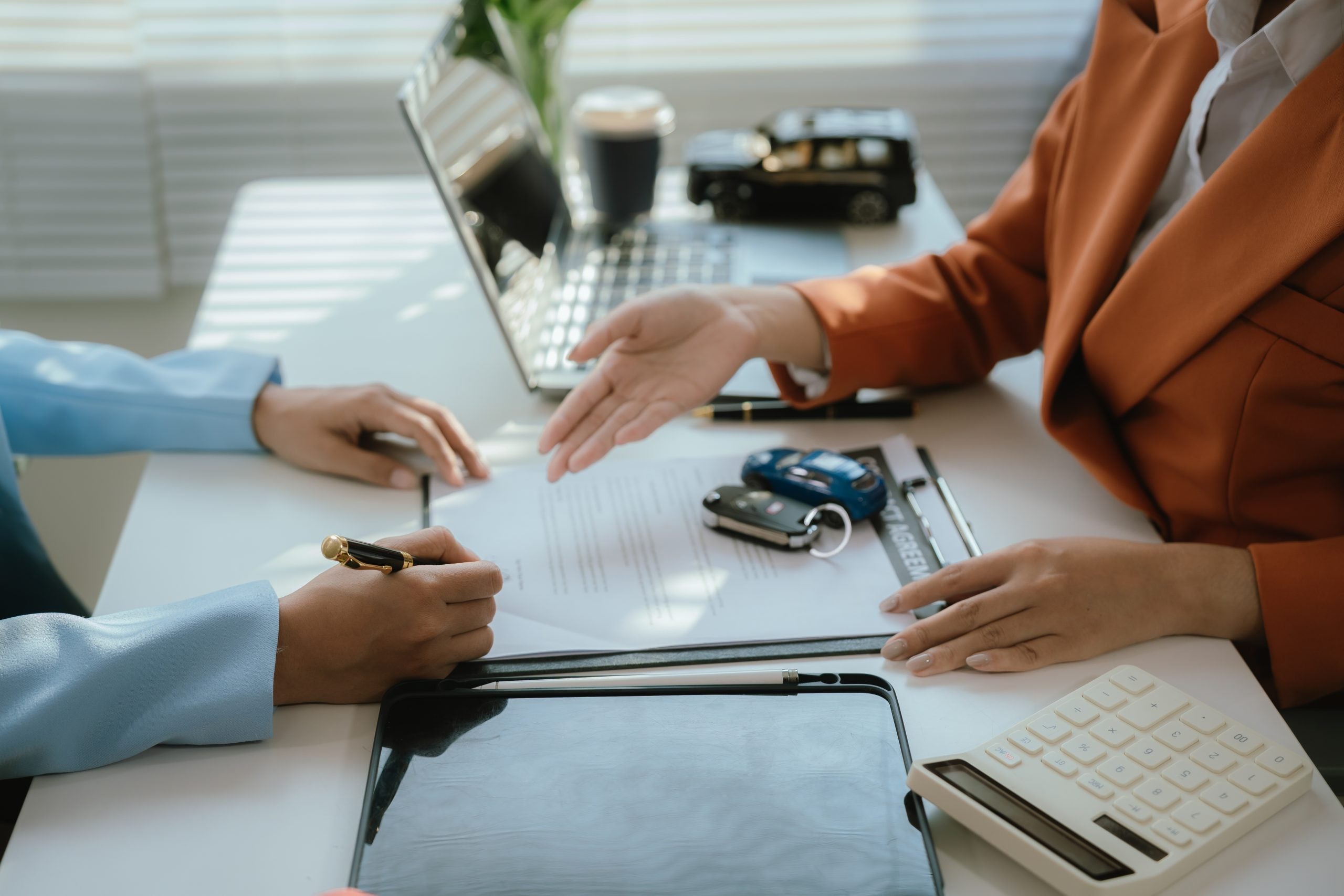 The salesperson meets with the new owner after signing the sales contract. This transaction includes financing, insurance, and legal documents to ensure a smooth and safe car sale or lease process.