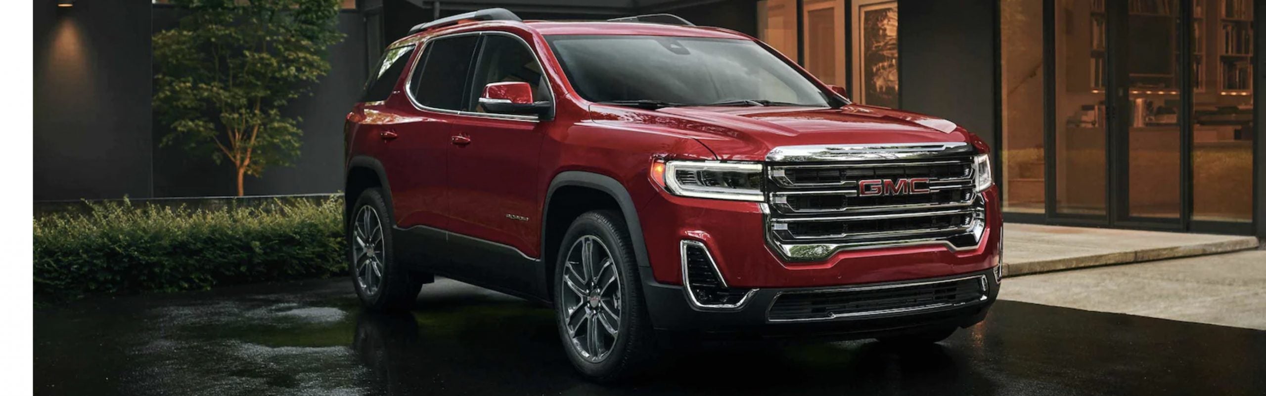 Red GMC Acadia parked on a driveway.