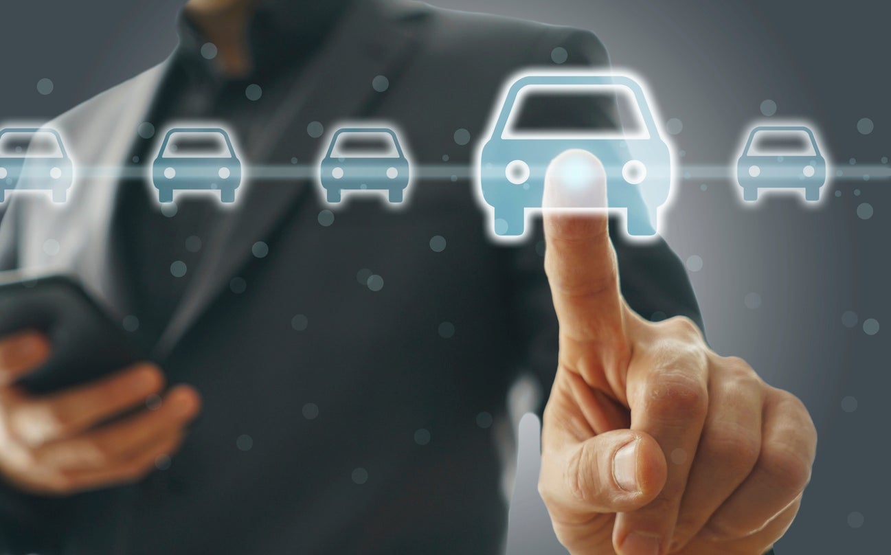 Digital car selection screen with male finger selecting vehicle