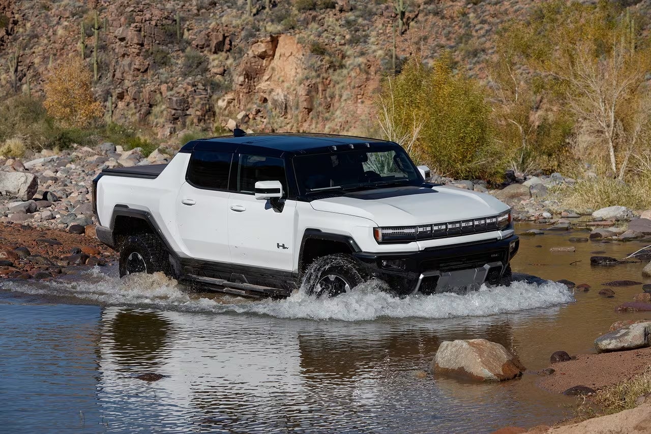 GMC Hummer EV driving through a small body of water