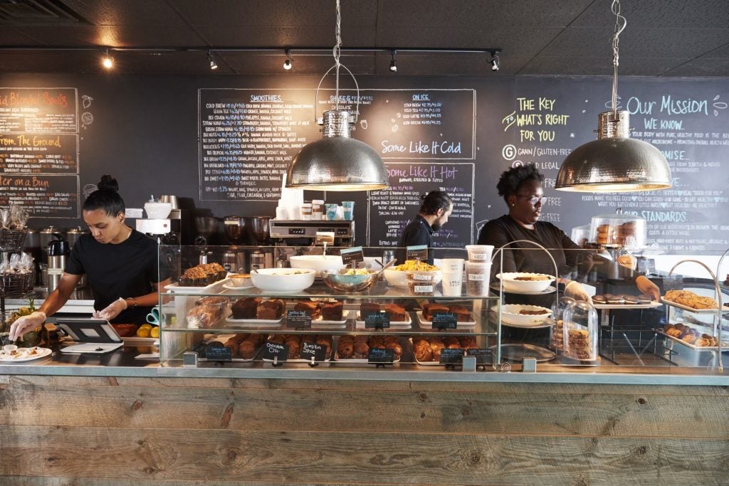 Three employees (2 female and 1 male) working at a local coffee shop.