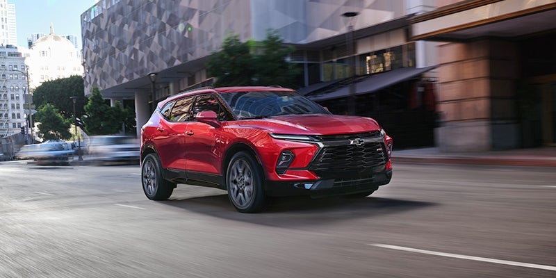 brand new red Chevrolet Blazer driving down city roads in Benton Harbor, MI