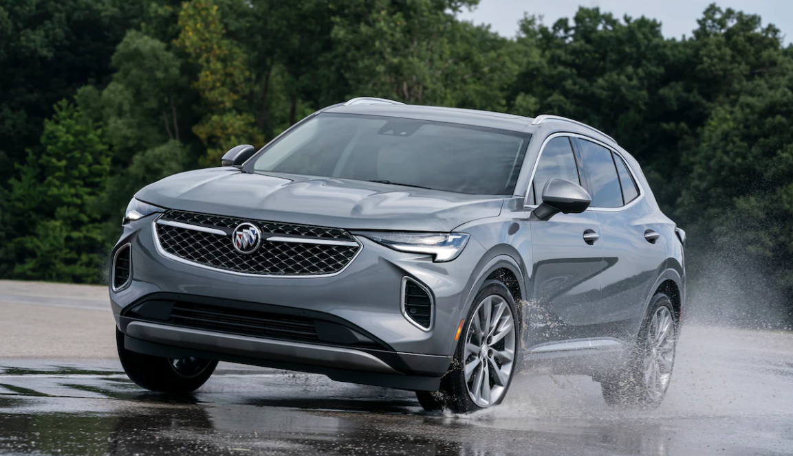 grey 2021 buick envision car driving on road with water