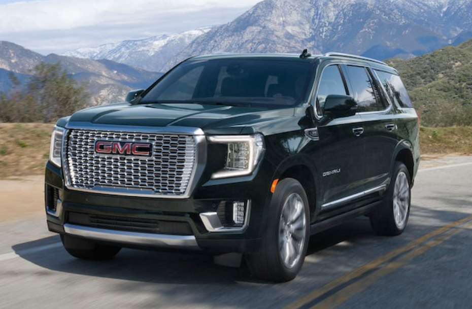 black 2021 GMC Yukon on the road front right angle view